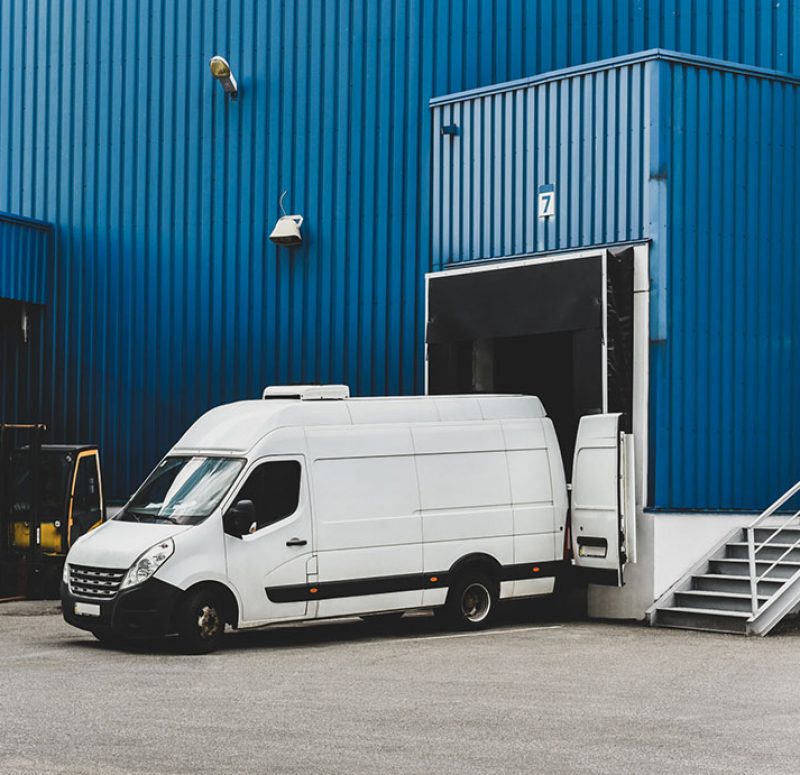 van in loading and unloading commercial cargo in warehouse dock